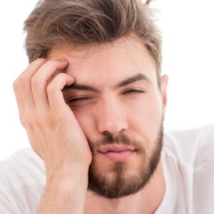 Picture of a sleepy bearded man leaning on his hand